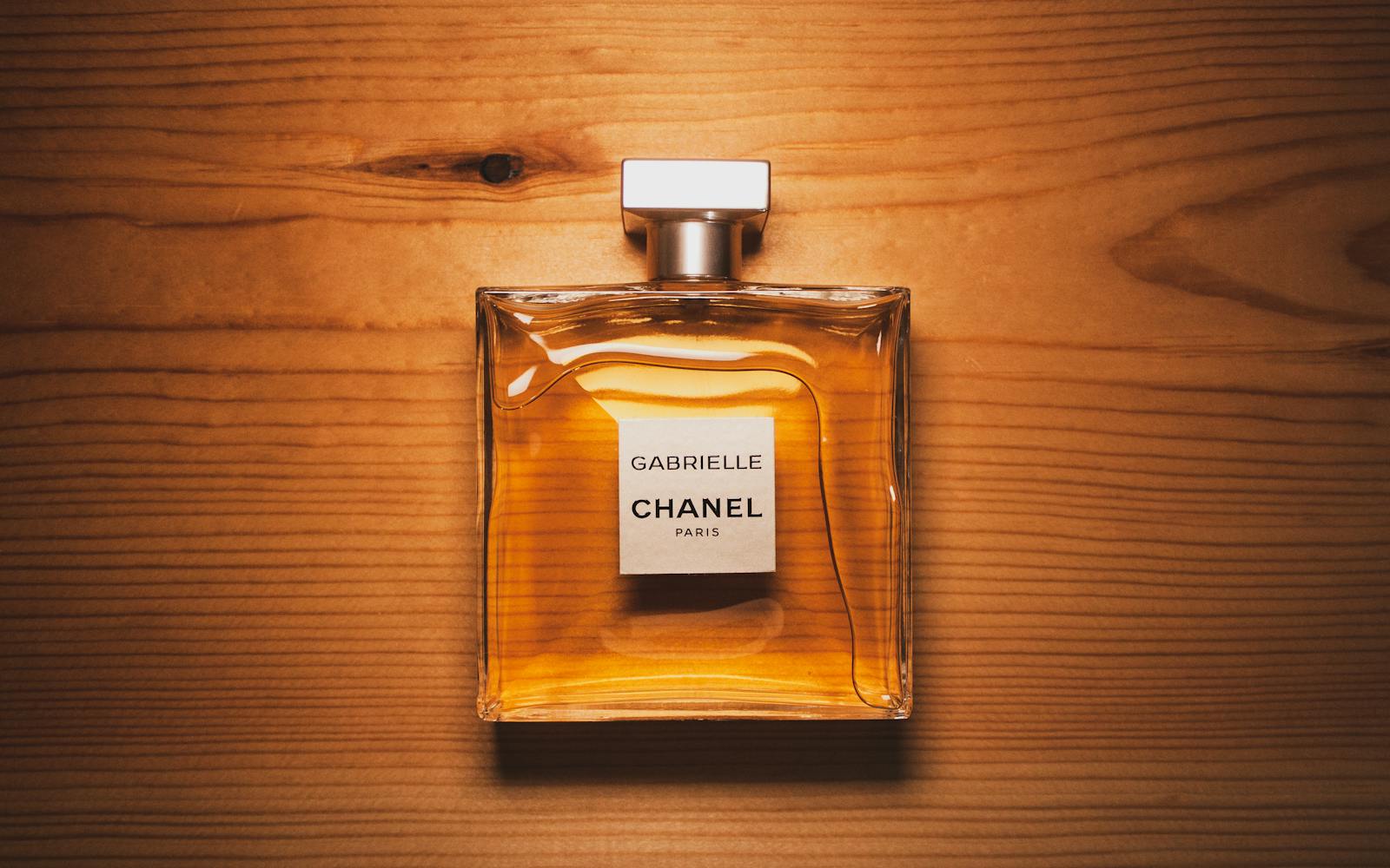 Elegant Chanel perfume bottle displayed on a warm wooden surface, showcasing luxury and style.